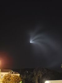 Low angle view of illuminated tree against sky at night