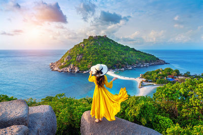 Woman looking at sea against sky