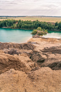 Picturesque landscape of sandy rocks and lake with blue or turquoise clear water. konduki, tula.