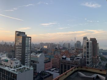 High angle view of city buildings against sky during sunset