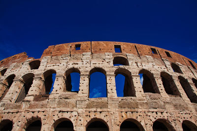 Low angle view of historical building against blue sky