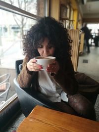 Woman drinking coffee at cafe