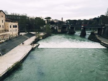 Bridge over river with buildings in background