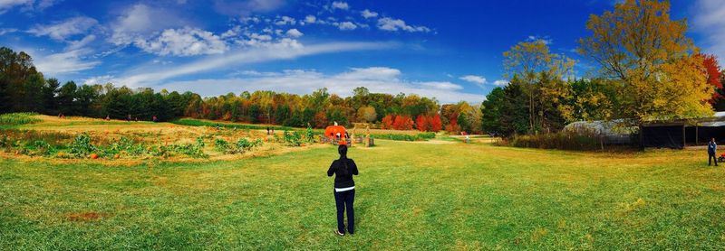 Full length of man standing on field against sky