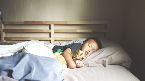 Young woman sleeping on bed at home