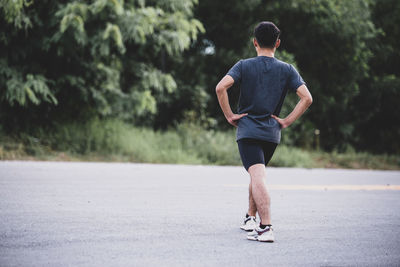 Rear view of man running on road