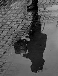 Low section of man with shadow on street
