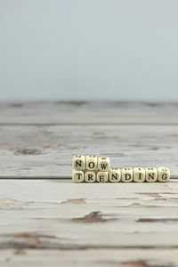 Close-up of text on beach against clear sky