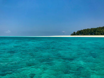 Scenic view of sea against blue sky