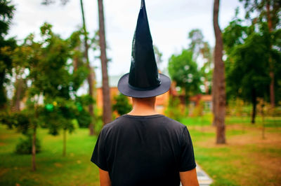 Back view of wizard in forest