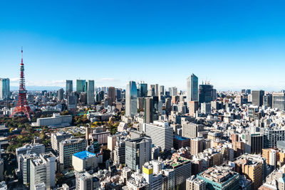 Aerial view of modern buildings in city against clear sky