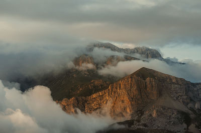 Smoke emitting from volcanic mountain against sky