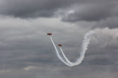 Low angle view of airplane flying against sky