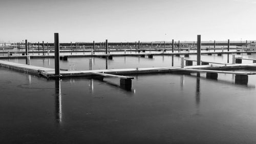 Pier on river against sky in city