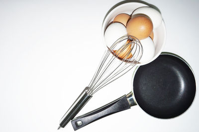 High angle view of eggs in container on table against white background