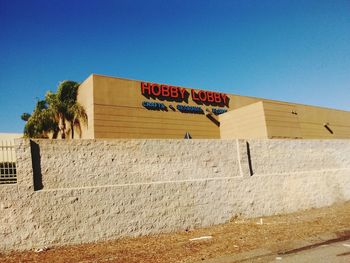 Low angle view of built structure against clear blue sky