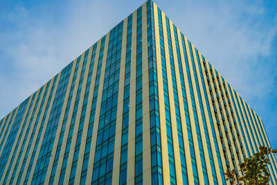 Low angle view of modern building against blue sky