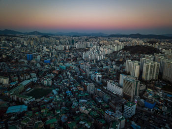 High angle view of city lit up at night