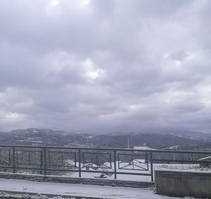 View of cityscape against cloudy sky