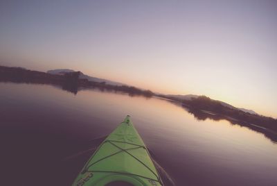 Scenic view of lake against clear sky during sunset