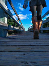 Low section of man walking on footbridge