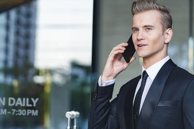 Businessman talking on mobile phone in office