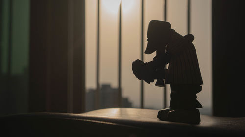 Side view of silhouette man at home