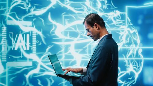 Side view of businessman using mobile phone