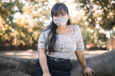 Portrait of young woman standing outdoors