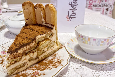 Coffee cup and cake on table