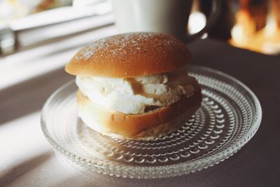 Semla served on a glass plate at a cafe 