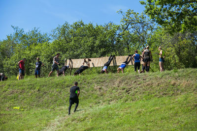 People on field against trees