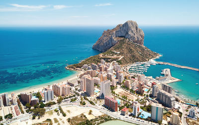 High angle view of sea and buildings against sky