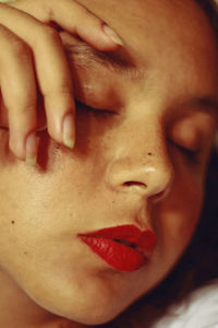 High angle close-up of young woman sleeping indoors