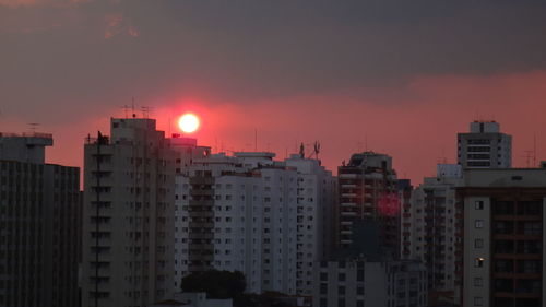Urban skyline against sunset
