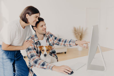 Couple working on desktop pc at home