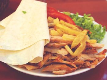 Close-up of burger and vegetables on plate