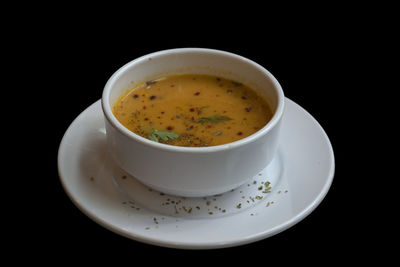 Close-up of tea cup against black background