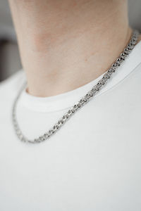 Midsection of man wearing chain