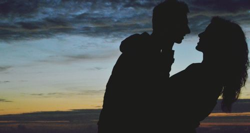 Silhouette of people at sunset