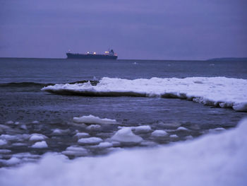 Scenic view of sea against sky during winter