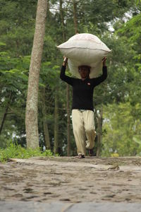 Full length of woman standing by tree