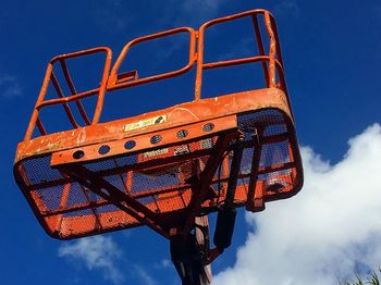 Low angle view of  a bucket truck. against  a blue sky 