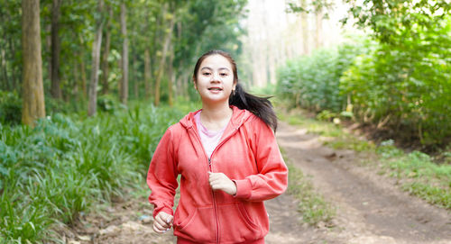 Portrait of a smiling young woman in forest