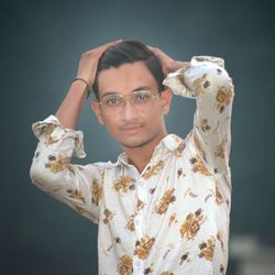 Portrait of a young man against white wall