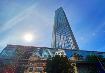 Low angle view of modern building against blue sky