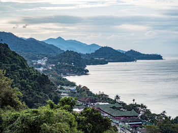 Scenic view of sea and mountains against sky