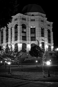 Illuminated building against sky at night