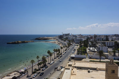 High angle view of road by sea against blue sky