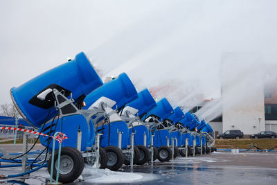 Bicycles parked in row against blue sky